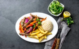 Authentic lomo saltado in Miami with beef, rice and French fries